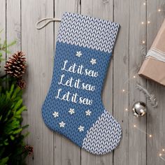 a blue christmas stocking with the words let it snow