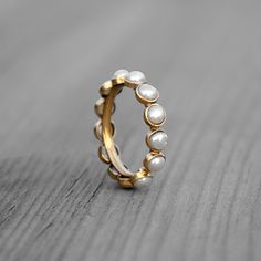 GemFormingStudio D E T A I L S Wedding Pearl Eternity Band | Gold Plated Pearl Ring | Pearl Engagement Ring | Ring For Women | Ring For Her | Stackable Ring | Gift For Her Gemstone : Pearl Ring Size: All sizes Available Weight: 2.11 gm Stone Size : 5 x5 mm Material: Brass Polish: All Polish Available . Contact us for wholesale prices. R I N G S https://www.etsy.com/in-en/shop/GemFormingStudio?section_id=22783374 B E A D S https://www.etsy.com/in-en/shop/GemFormingStudio?section_id=22828835 W A N Channel Setting Ring, Channel Set Rings, Pearl Engagement Ring, Channel Setting, Electroformed Jewelry, Stackable Ring, Dream Jewelry