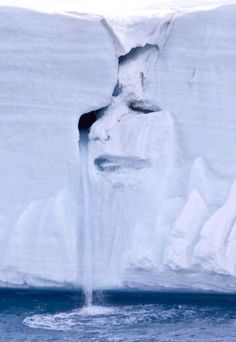 an iceberg with water pouring out of it