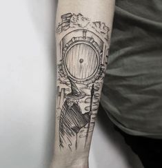 a man's arm with a tattoo on it and an image of a barrel