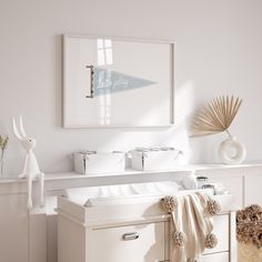 a white bathroom with a sink, mirror and towels on the counter top in front of it