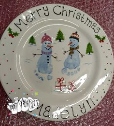 a white plate with two snowmen on it and merry christmas written on the side