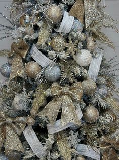 a christmas tree with silver and gold decorations