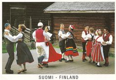 a group of people dressed in costumes standing next to each other on a wooden platform