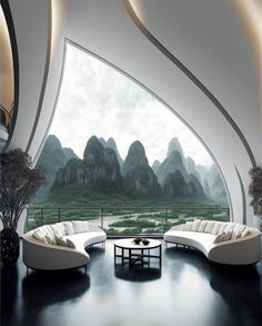 a living room filled with white furniture and mountains in the backgroung area