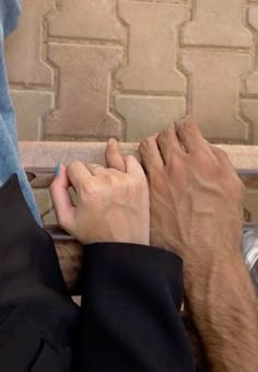 two people with their hands on each other's legs, sitting next to each other