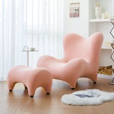 a pink chair and ottoman in a white room