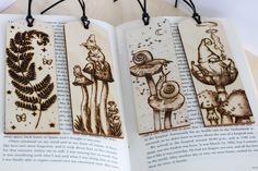 an open book with three wooden tags hanging from it's sides and two pictures of mushrooms on them