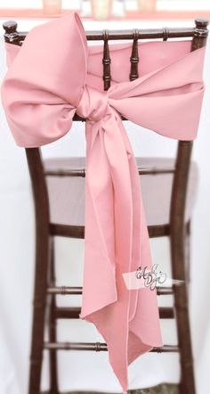 a chair with a pink bow tied to it