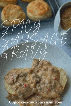 a plate with biscuits and gravy on it next to some other food items