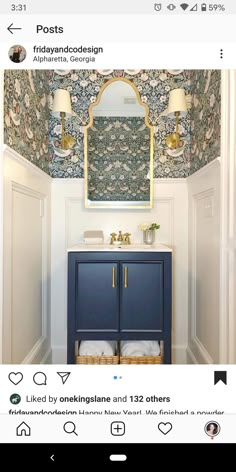 an instagram page with a blue vanity and wallpaper on the walls in a bathroom