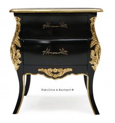 an ornate black and gold chest of drawers with two drawers on each side, one drawer open