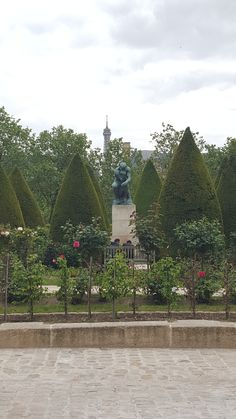 there is a statue in the middle of this garden