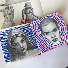 some drawings are sitting on a table next to papers with pictures of women's bodies