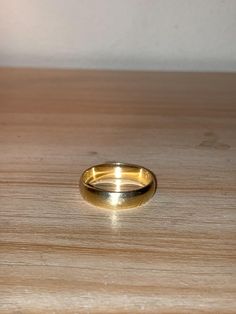 a gold ring sitting on top of a wooden table