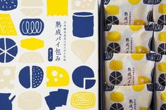 an assortment of different types of food wrapped in wrapping paper with japanese characters on them