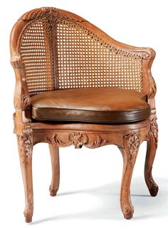 an old wooden chair with leather seat pad