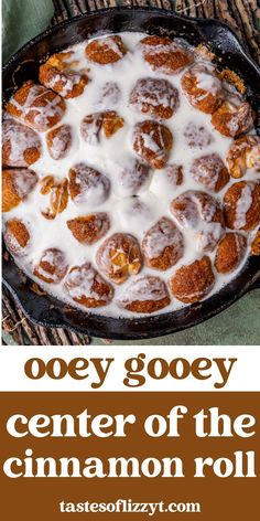 a cinnamon roll in a cast iron skillet with the words ooey gooey center of the cinnamon roll