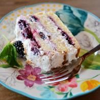 a piece of cake on a plate with a fork and flowered design around it