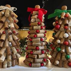 three wine cork christmas trees on a mantle