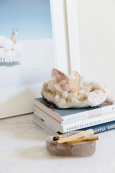 a stack of books sitting on top of a table next to a pair of scissors