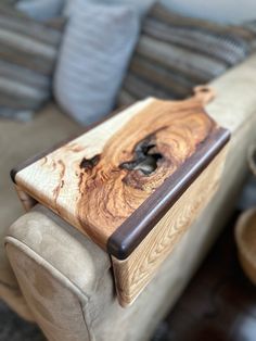 a wooden table sitting on top of a couch