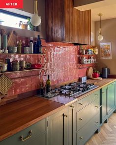 a kitchen with green cabinets and pink tiles on the backsplash is seen in this image