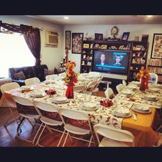 a dining room table is set with plates and place settings for people to sit at