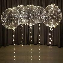 some lights are hanging from the ceiling in front of a curtain and black drapes