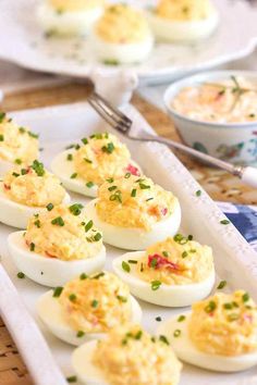 deviled eggs are arranged on a white tray