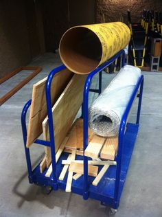 there is a large pipe on the back of a cart with some wood in it