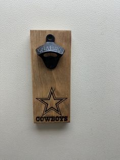 a bottle opener mounted to the side of a wall with an nfl logo on it