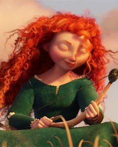 a red haired woman with long hair sitting on top of a green pillow holding a bow