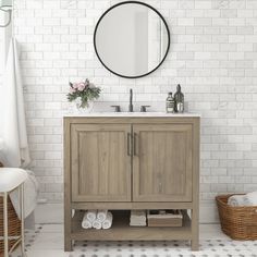 a bathroom with white brick walls and a wooden cabinet under a round mirror on the wall