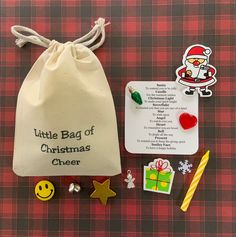 a little bag of christmas cheer and other items on a plaid tablecloth with tags