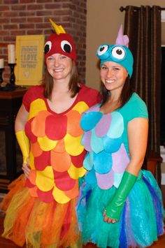 two women dressed in costumes standing next to each other