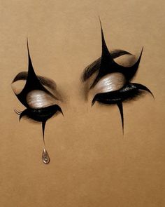 an artistic drawing of two eyes with tears