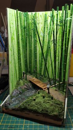 an image of a card with bamboo trees and water in the middle, on a cutting board