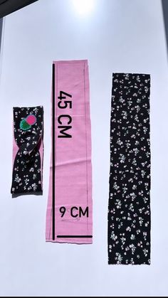 three pieces of clothing are displayed on a white surface with black and pink floral print