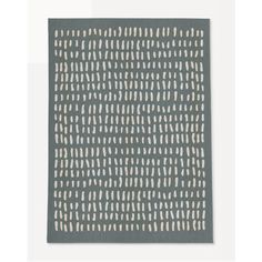 a gray and white area rug with an abstract design