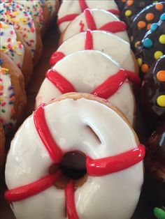 there are many donuts with white frosting and sprinkles on them