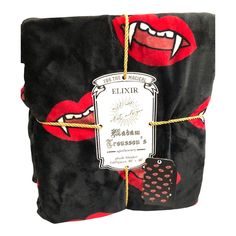 a black blanket with red lips on it and a tag that says elixir