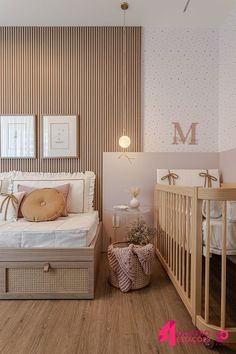 a baby's room with two cribs, a cot and pictures on the wall