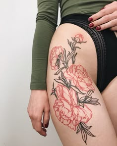 a woman's thigh with flowers on it