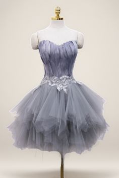 a dress on a mannequin with white and purple flowers in the skirt, it is