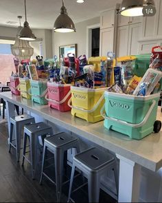 several coolers are lined up on the counter in front of two bar stools