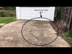 a driveway with water pools in it and an arrow pointing to the garage door that says, water pools in this area