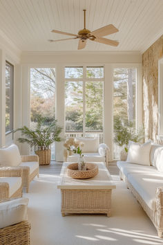 a sun room with wicker furniture and large windows