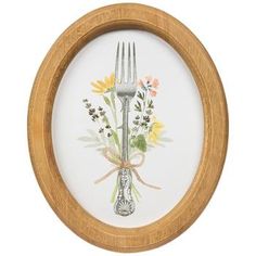 a wooden frame with a fork and flowers painted on the front, in an oval shape