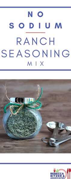 a glass jar filled with ranch seasoning on top of a wooden table